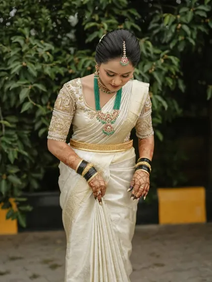 The elegance of a Kanjivaram saree is timeless. Harshitha drapes her saree perfectly, showcasing its rich texture.