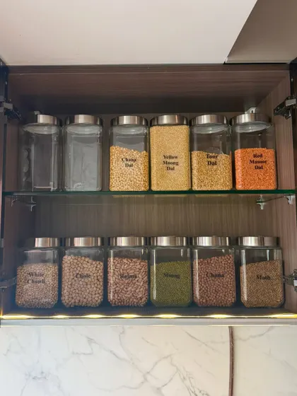 This cabinet is dedicated to dals and pulses, essential in any Indian kitchen. We arranged them by type and color, making it visually appealing and highly practical for daily cooking.