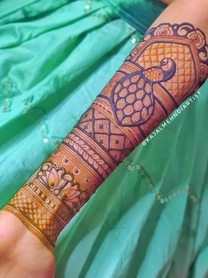 A bold peacock design on the arm, perfect for making a statement at a wedding or festival.