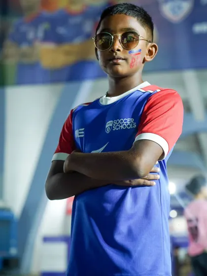 A young fan shows off his style game in the new BFC Soccer Schools kit at a first-team match.