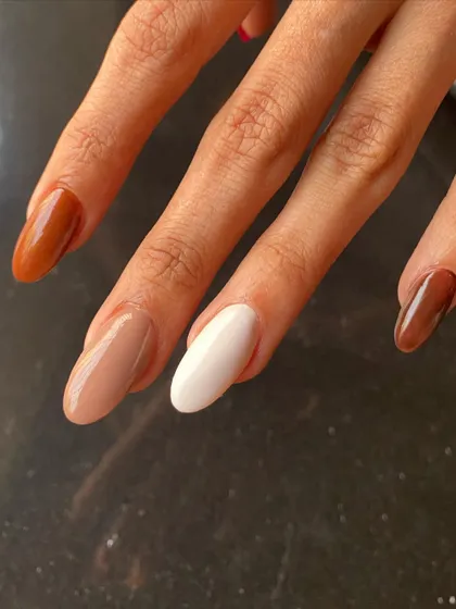 A trendy and sophisticated look with acrylic extensions in shades of brown and cream.