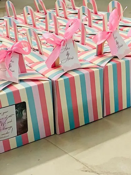 A row of our completed baby shower favor boxes, each consistently packaged and ready for the event.