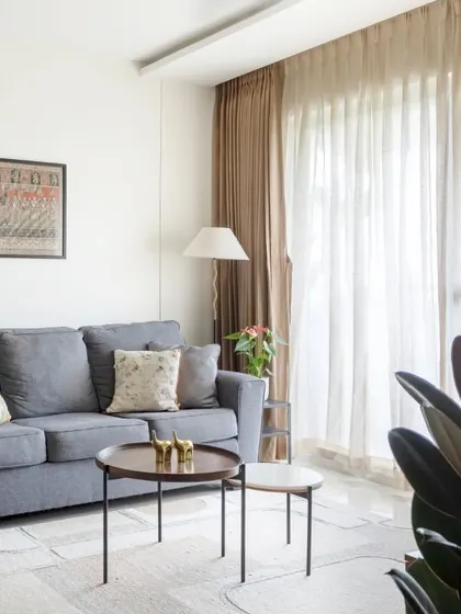 A similar shot of the living room, focusing on the comfortable seating and natural light.