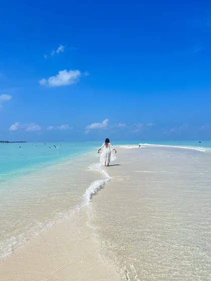 Walking along a beautiful sandbank in the Maldives, feeling completely connected to the elements of water and air.