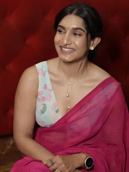 The stunning Krishi Thapanda in a deep pink chiffon saree paired with a custom floral print blouse with a plunging neckline.
