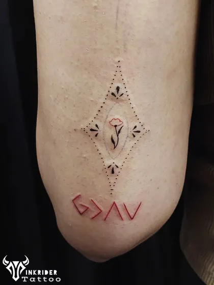 The phrase "God is greater than the highs and lows" represented by the minimalist symbol G>AV. We inked this one with a pop of red ink for a unique look.