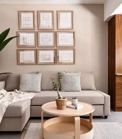 The study's gallery wall, featuring the client's late father's carpentry sketches. This personal touch is complemented by a modern puja unit with geometric CNC-cut shutters.