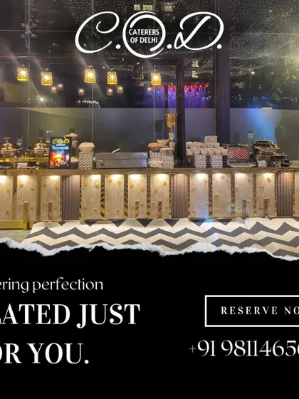 Our catering setups are designed to be a perfect fit for modern, elegant venues. This image shows a clean, white and gold buffet line with minimalist hanging lights, ready for an evening of celebration.