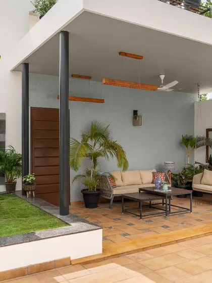 We transformed this terrace into a serene outdoor lounge. The design provides a covered seating area for relaxation, surrounded by lush greenery, creating a perfect escape with views of the Bangalore skyline.