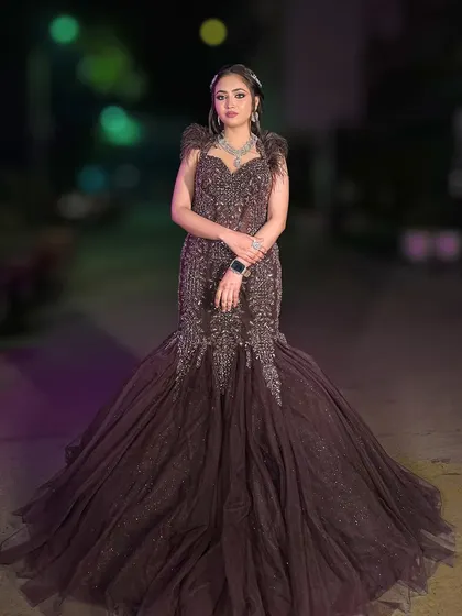 A full-length shot of the wine-colored fish-cut gown, showcasing its dramatic train and flattering silhouette.