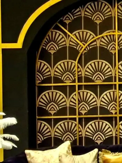 For a glamorous, Art Deco-inspired event, we created this stunning backdrop using a black and gold fan pattern. This type of custom fabrication is one of our specialties.
