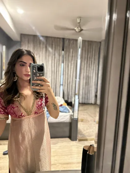 A mirror selfie showing a brocade top I designed. I often mix and match my self-designed pieces to create new looks.