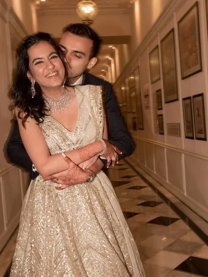There's so much love in this photo. A beautiful, candid moment from a reception, with the bride looking absolutely radiant and happy.