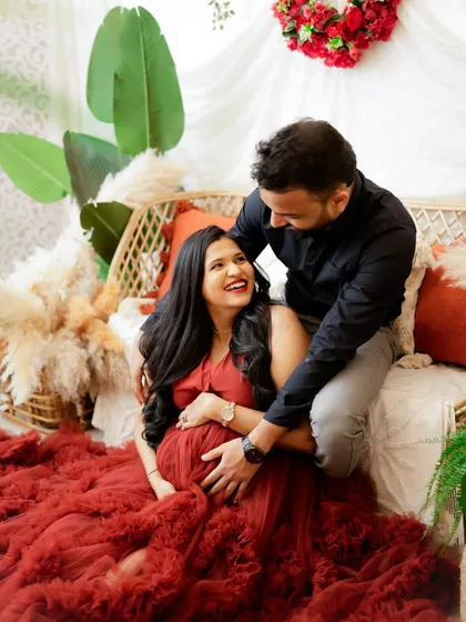 A candid moment of laughter and love. This couple's joy is infectious as they share a happy moment during their maternity session.