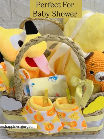 Perfect for a baby shower, this unisex gift basket is overflowing with yellow-themed goodies, including multiple soft toys and clothing essentials for the newborn.