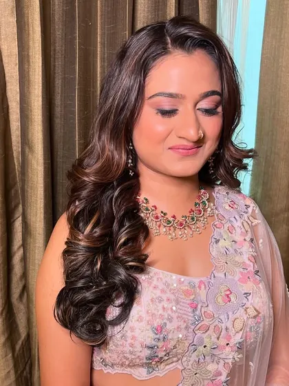 My bride Vini, looking beautiful for her reception in a pastel floral lehenga with soft, romantic makeup.