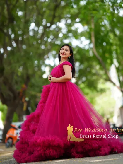 A graceful pose in the magenta ruffled gown, highlighting its voluminous skirt.