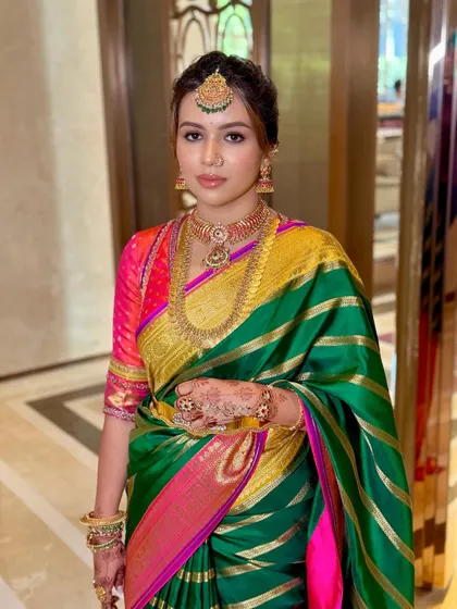 Deeksha's full portrait, showcasing the vibrant colors of her Gaurang Shah saree and the timeless elegance of her South Indian bridal makeup.