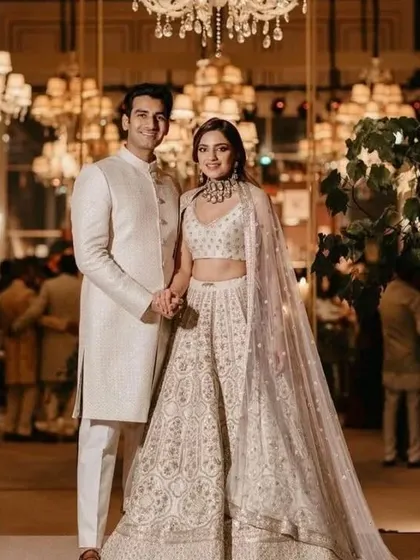 An all-white theme can be incredibly striking. I designed this couple's outfits with detailed, matching embroidery to create a look of pure elegance for their special day.