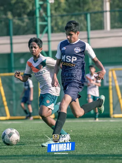 A player drives past a defender, demonstrating speed and dribbling skill.
