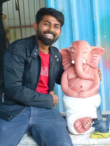A happy moment with a completed Ganesha idol. The sculpture has been painted and is now ready to be placed in an altar. I am sitting next to it to give a sense of its size and presence.