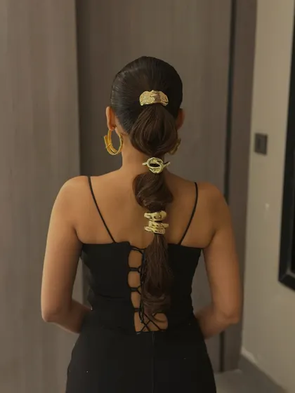 A full view of the accessorized ponytail, showing how it creates a bold statement from the back.