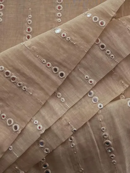 This mirror-work Mul Chanderi in a neutral beige tone is perfect for creating festive outfits that are both elegant and celebratory.