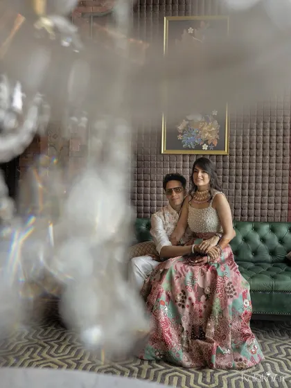 An artistic indoor portrait with a modern, luxurious city vibe. We used a crystal foreground to create this dreamy, glamorous effect for an engagement shoot.