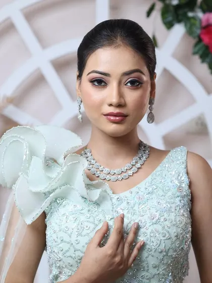 New-age minimal glam. This look, with its clean ponytail and soft makeup, is perfect for the modern woman who wants to look polished and chic for her special event.