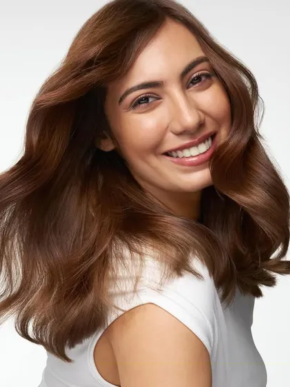An alternate take from a Dove haircare shoot, capturing natural movement and shine. This image, with its clean white background, is versatile for use in digital ads, print, and packaging.