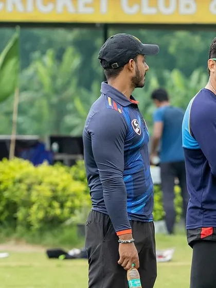 On the field with the team during a practice match. Observing and analyzing every aspect of the game.