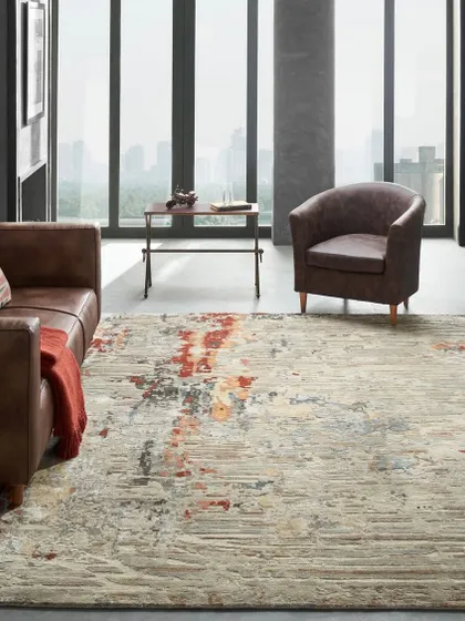 A modern living room with a city view, grounded by an abstract-patterned rug. The clean lines of the furniture and the open space emphasize a contemporary urban lifestyle.