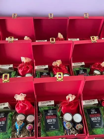 Rows of our red suitcase hampers, packed and ready for dispatch. We can handle large volumes to meet your corporate gifting deadlines.