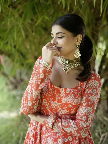 Another close-up of the orange floral Anarkali, showing its flattering fit.