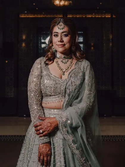 A lovely portrait of the bride, showcasing her elegant cocktail party look, from her hair and makeup to her beautiful jewelry.