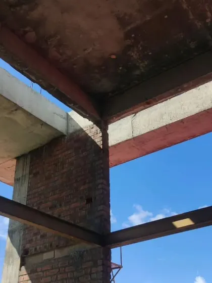 A detail of the structural corner where steel beams meet the concrete frame.