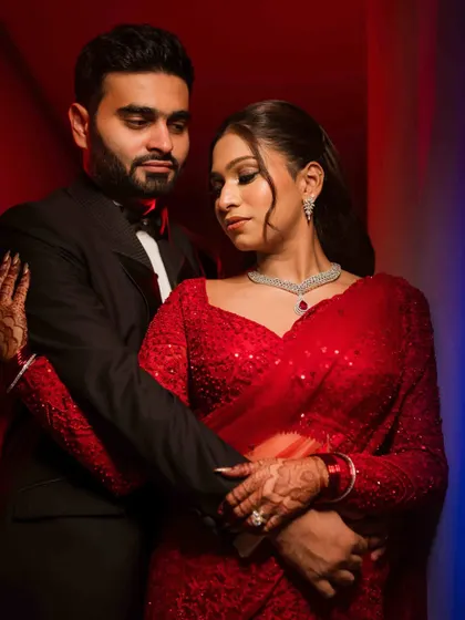 A dramatic and intimate portrait of the couple. The red and blue lighting adds a modern, cinematic feel to this reception look.