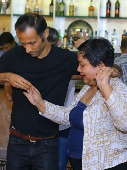 A couple dancing by the bar, showcasing how the entire venue becomes a dance floor at our parties.