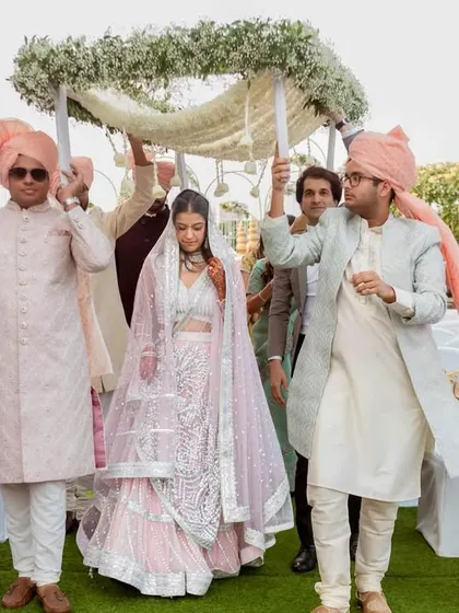 The bride's entrance under the 'phoolon ki chadar', held by her brothers. A classic and beautiful Indian wedding tradition.
