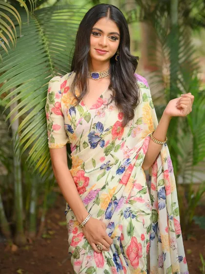 A close-up of the white floral saree, showing its delicate print and beautiful drape.