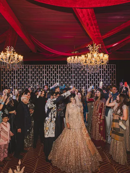 The couple taking a selfie with all their guests at the Sufi night. A modern moment in a timeless setting.