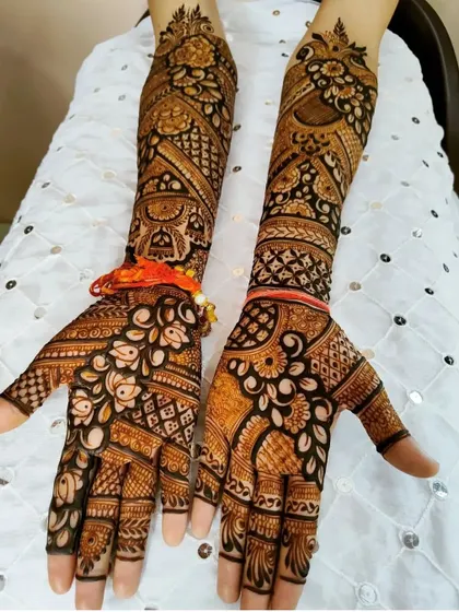 This design uses a mix of bold floral work and delicate check patterns, showing great contrast and detail.