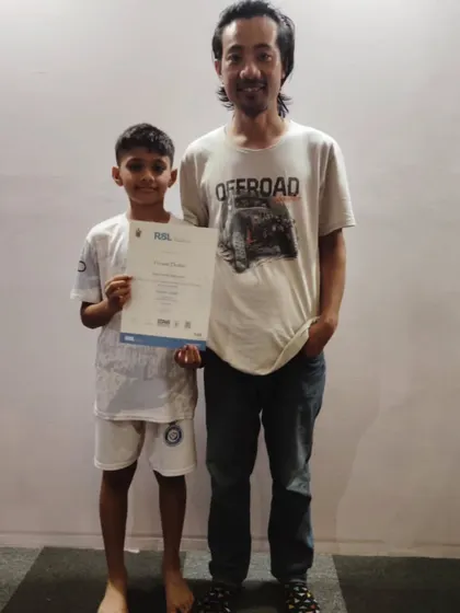 Vivan proudly holds his RSL debut certificate for acoustic guitar, which he passed with distinction. We celebrate the success of our students and their teachers.