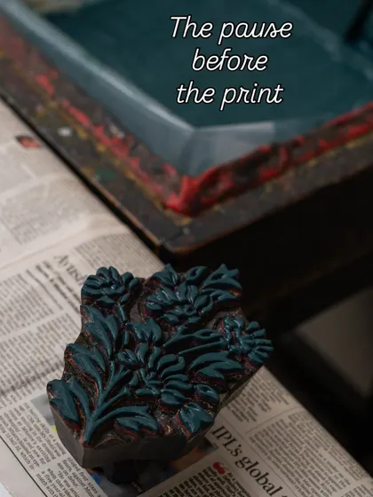 The pause before the print. A moment of quiet anticipation as the inked block is ready to make its mark. This is where the story begins.