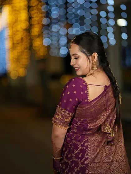A beautiful back shot of Iva's reception outfit, showing the delicate tassels and the rich texture of the brocade blouse.