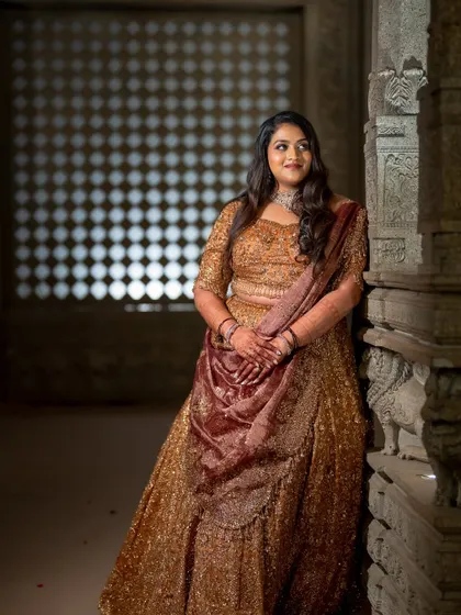 A relaxed and happy portrait of the bride leaning against an ancient stone pillar. Her genuine smile lights up this beautiful, textured frame.