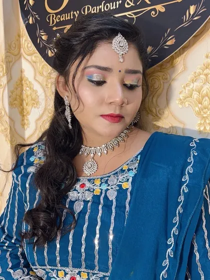 A party look with shimmery blue and silver eyeshadow and a simple diamond-style jewellery set.