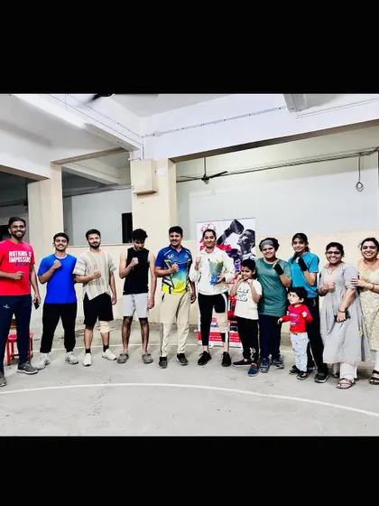 The whole team, including our youngest members, celebrating a victory. This family atmosphere is key to our academy's culture and helps build a strong support network for our fighters.