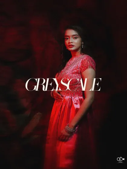 An artistic and dramatic portrait of the bride in a red dress, with the word "Greyscale" overlaid, creating a high-fashion, conceptual image.