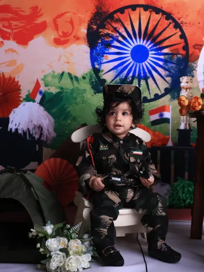 Dressed in a miniature army uniform, this child looks ready to protect the nation. It's a unique and powerful theme for an Independence Day photoshoot.